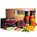 Spicy food kit with hot sauce bottles, snacks, and packaging on a white background