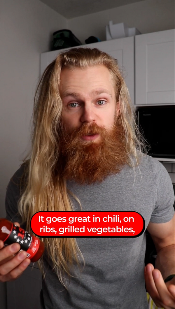 Man with long hair and beard holding a red pepper, with text overlay about its uses.